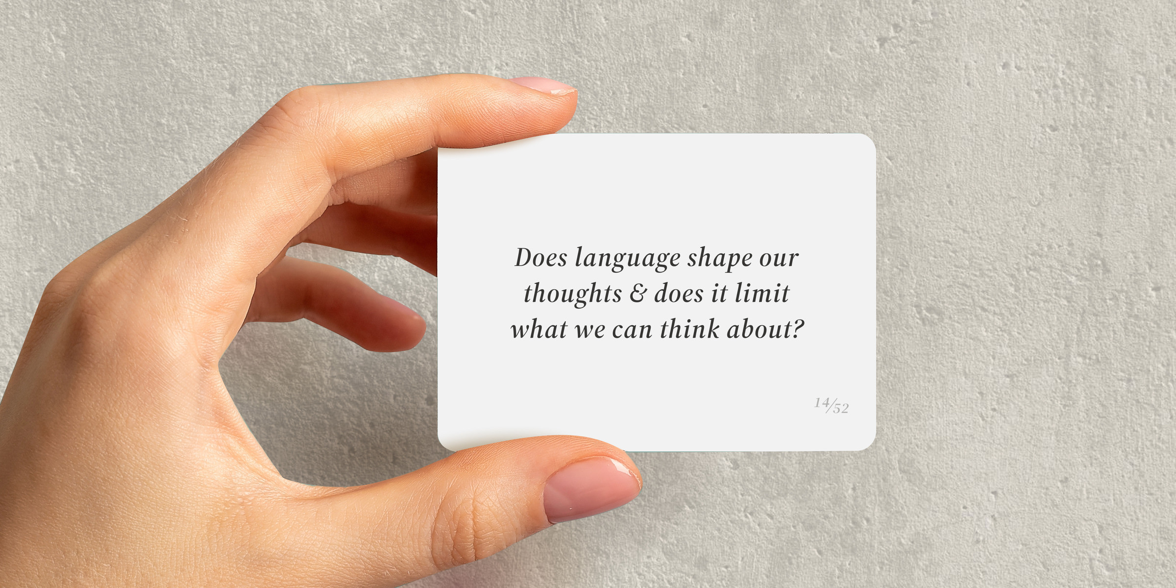 A hand holding card 14: Does language shape our thoughts & does it limit what we can think about?